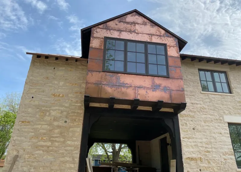 Copper metal panel facade on a stone building for Roof Repair in Dodge City
