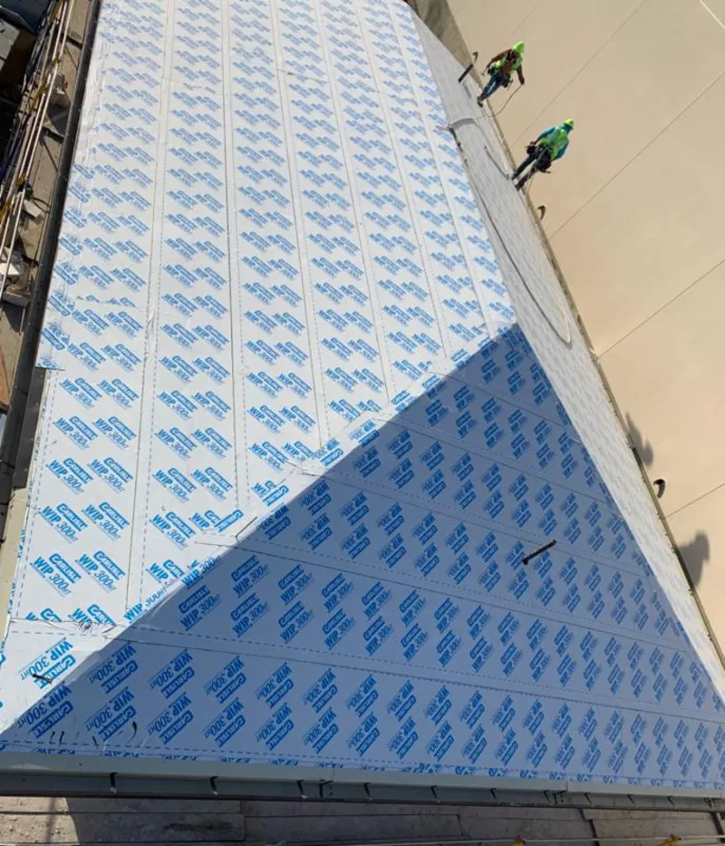 Professional roofers installing underlayment on a metal roof in Dodge City